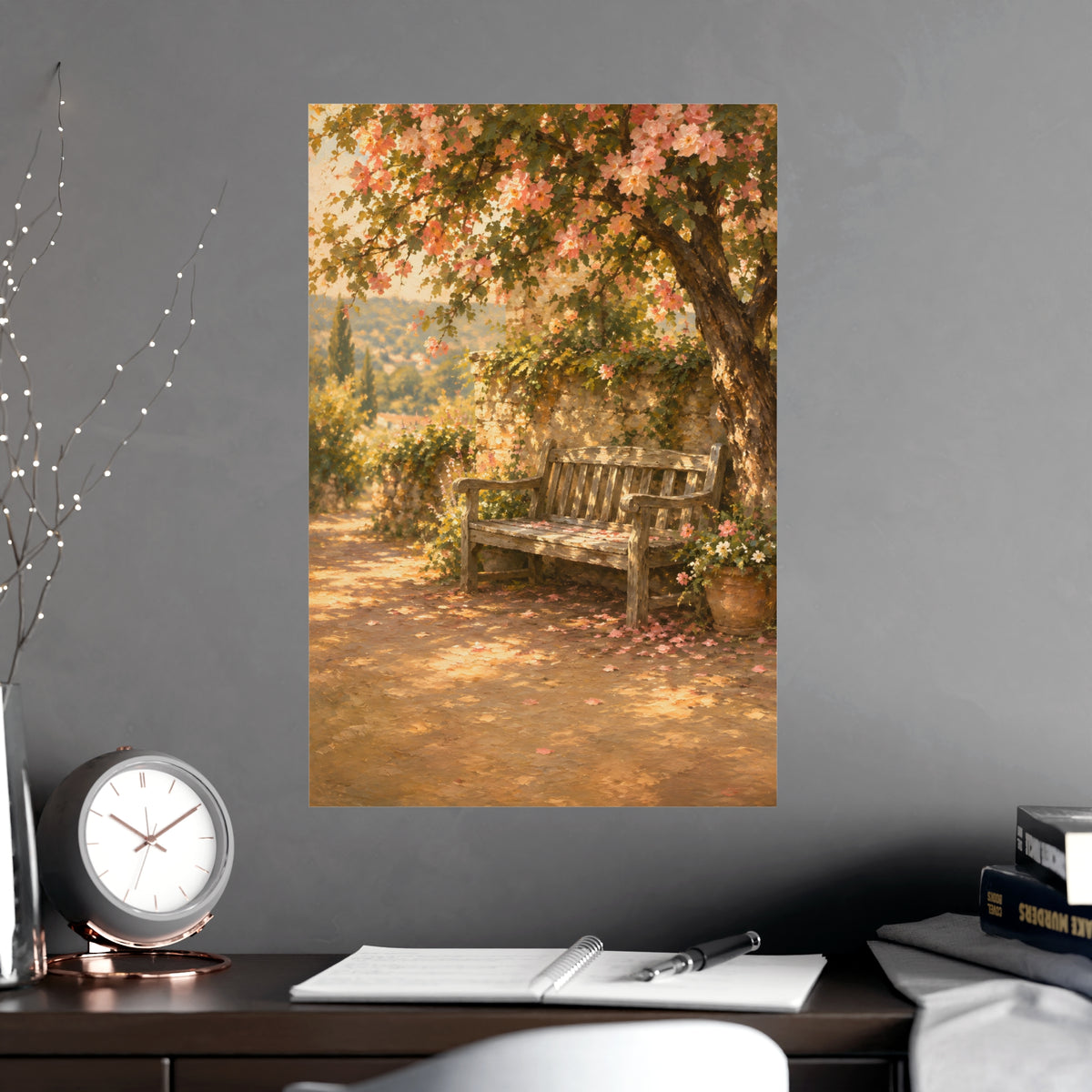 Bench Under Blossom — a weathered wooden bench under a flowering tree in a quiet garden, shown framed on a wall
