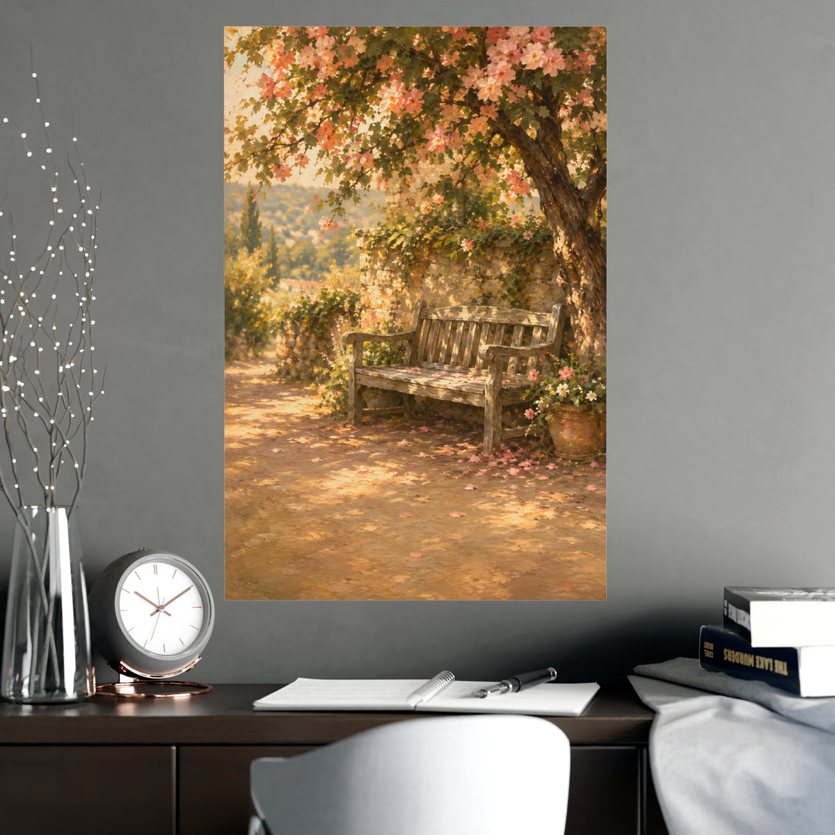 Bench Under Blossom — a weathered wooden bench under a flowering tree in a quiet garden, shown framed on a wall