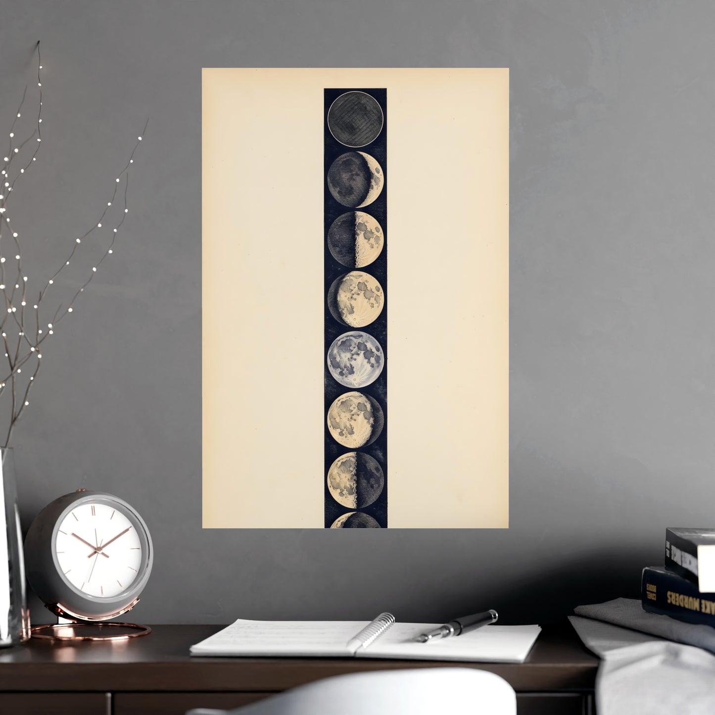 Phases of the Moon hung above a desk with a clock and notebook, 18x24 in print
