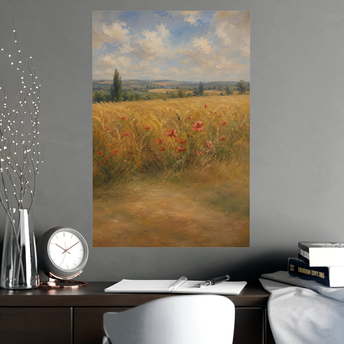 Poppies in the Wheat — wheat fields under a wide summer sky with poppies scattered through the gold, shown framed on a wall