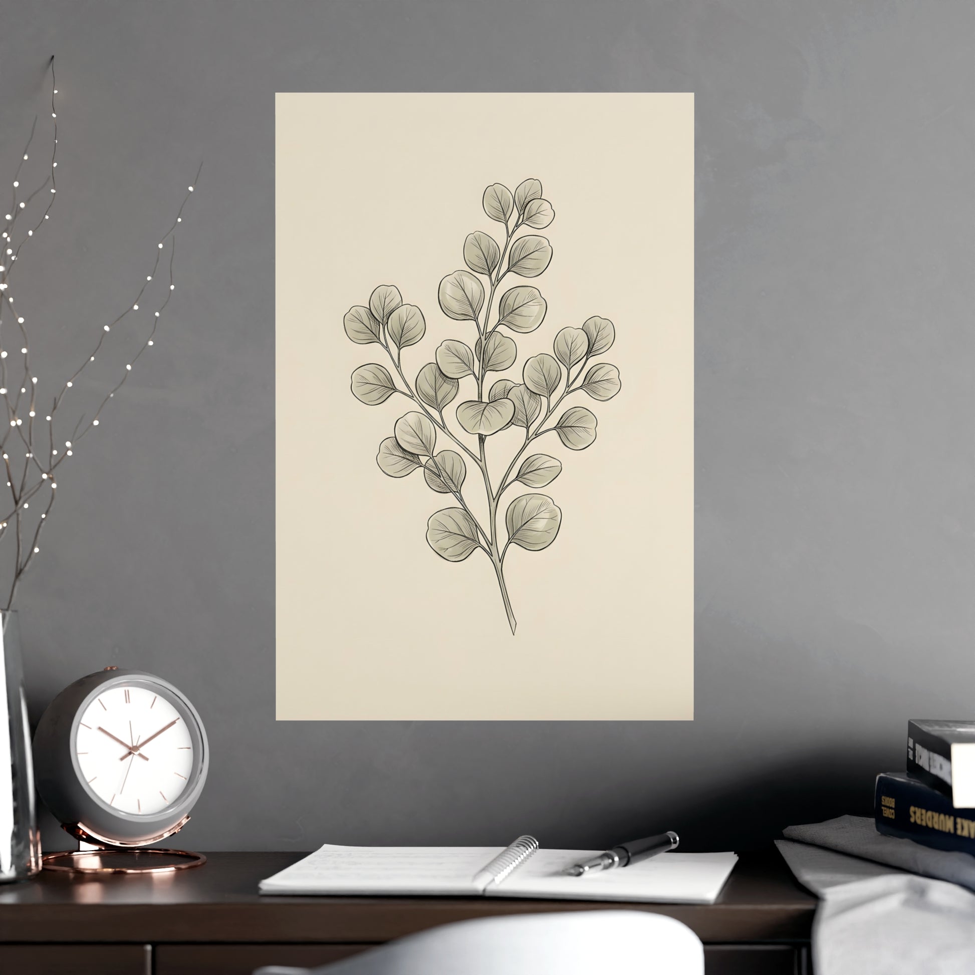 Eucalyptus hung on a grey wall above a dark sofa, 16x24 in print