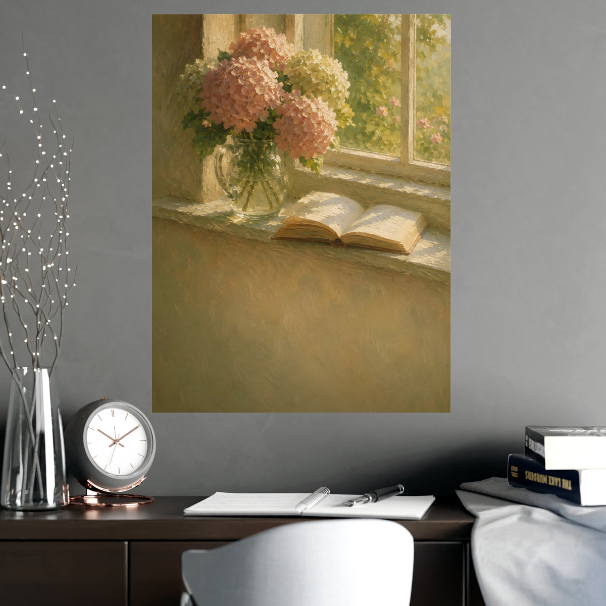 Hydrangeas and a Book — hydrangeas in a glass jug beside an open book on a sunlit windowsill, shown framed on a wall
