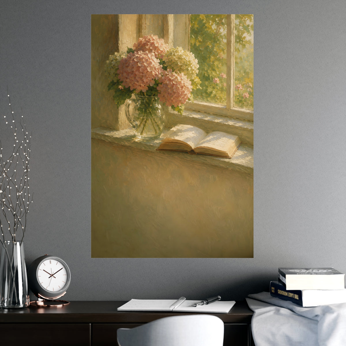 Hydrangeas and a Book — hydrangeas in a glass jug beside an open book on a sunlit windowsill, shown framed on a wall