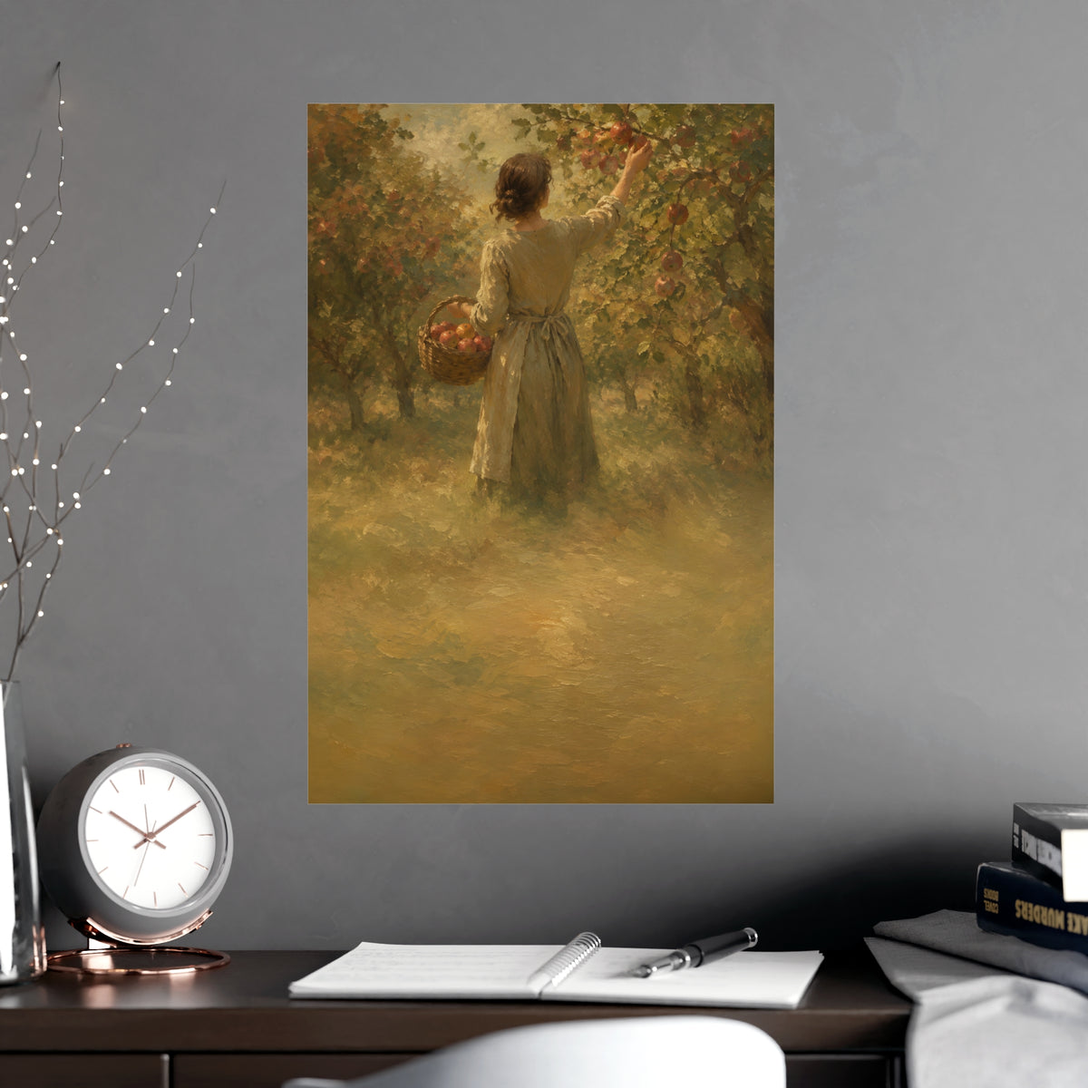 Picking Apples — a woman picking apples in an orchard in early autumn, seen from behind, shown framed on a wall