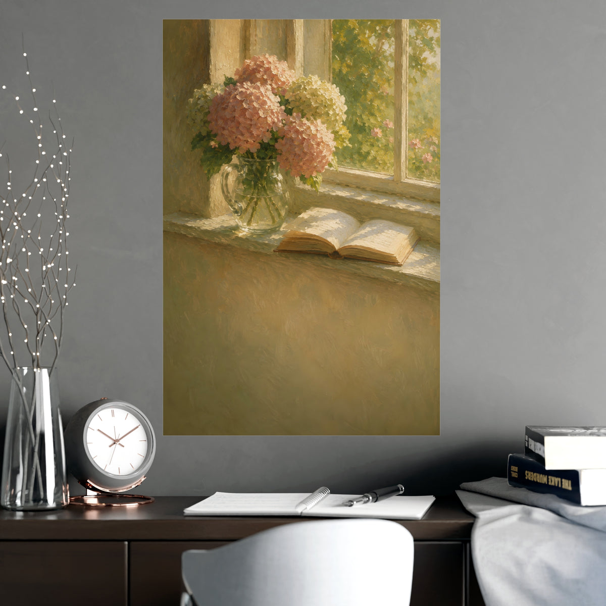 Hydrangeas and a Book — hydrangeas in a glass jug beside an open book on a sunlit windowsill, shown framed on a wall