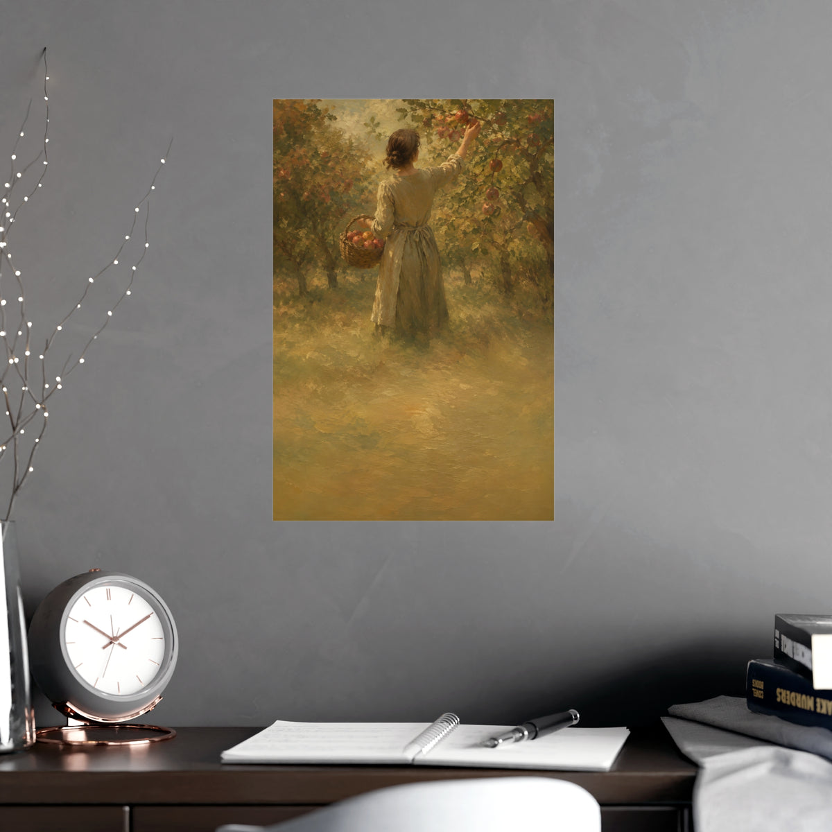 Picking Apples — a woman picking apples in an orchard in early autumn, seen from behind, shown framed on a wall