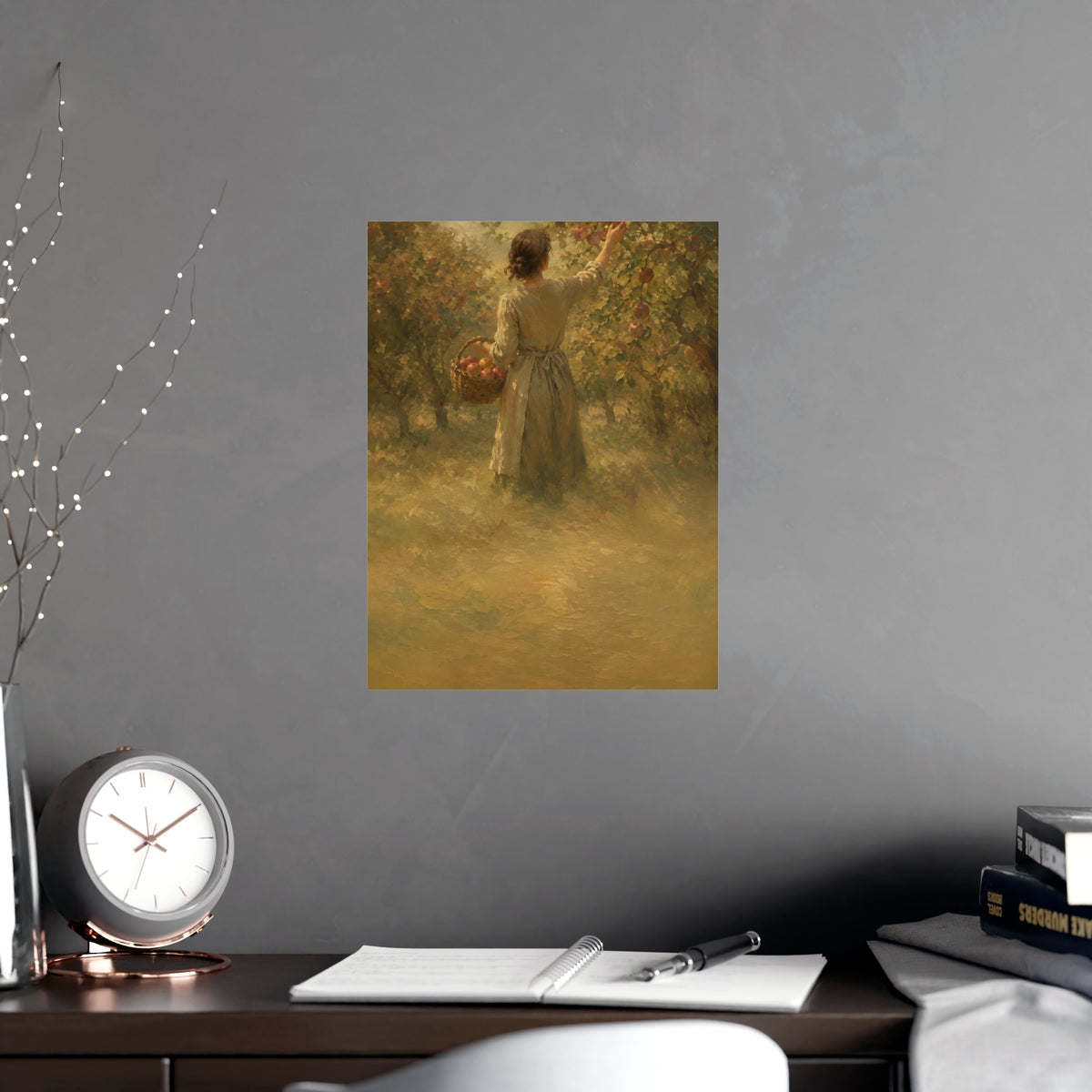 Picking Apples — a woman picking apples in an orchard in early autumn, seen from behind, shown framed on a wall